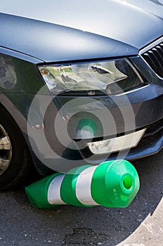 Car bending white and green safety traffic post with front bumper, wrong parking, car insurance, fine, penalty