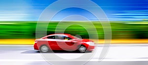 Car in blurred motion on road. Abstract background.