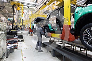 Car bodies are on assembly line. Factory for production of cars. Modern automotive industry. A car being checked before
