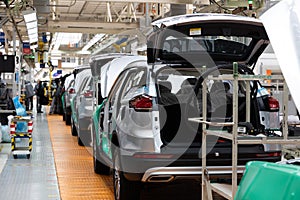 Car bodies are on assembly line. Factory for production of cars. Modern automotive industry. Electric car factory