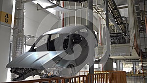 Car bodies on the production line. Skeleton of car moves along the conveyor. Car factory.