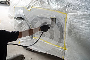 Car body work after the accident by preparing automobile for painting during repair