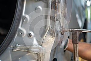 Car body work after the accident by preparing automobile for painting during repair