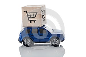 Car with a box on the roof isolated on a white background. The concept of fast delivery, transport logistics