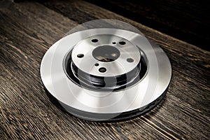 Car brake diske on wooden background