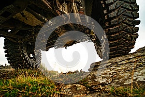 Car brakes with absorbers. Car tire. Extreme off road tour in a forest. Water splash in off-road racing. Off road car on