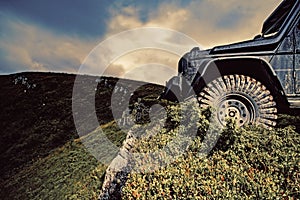 Car brakes with absorbers. Car tire. Tire for offroad. Truck car wheel on offroad steppe adventure trail. Wheel close up