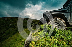 Car brakes with absorbers. Car tire. Tire for offroad. Truck car wheel on offroad steppe adventure trail. Wheel close up