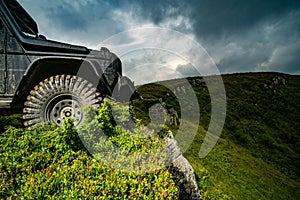 Car brakes with absorbers. Car tire. Tire for offroad. Truck car wheel on offroad steppe adventure trail. Wheel close up