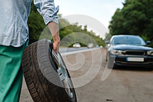 Car breakdown, man puts the spare tyre