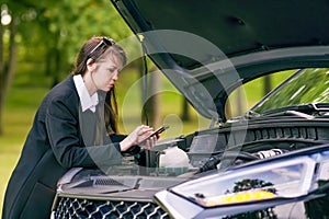 Car breakdown on the road. woman with broken car calling for help. Need car service help