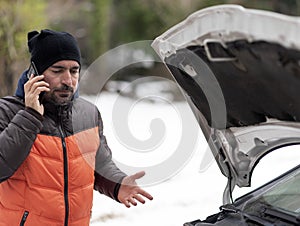 Car breakdown on a snowy winter day