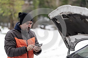 Car breakdown on a snowy winter day