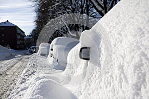 Car buried in snow, side view mirror