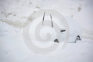 Car buried under a thick layer of snow after snow storm