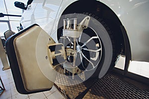 A Car on the Car Steering Wheel Balancer and Calibrate with laser reflector attach on each tire to center driving adjust