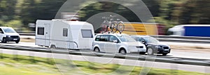 Car with a caravan highway speed blur