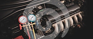 Car care maintenance and servicing, Close-up measuring manifold gauge on car engine for check refrigerant and filling air