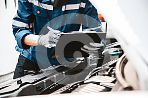 Car care maintenance and servicing, Hand technician auto mechanic checking inspection list after fix or repairing change spare