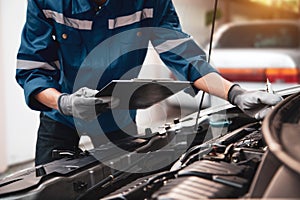 Car care maintenance and servicing, Hand technician auto mechanic checking inspection list after fix or repairing change spare