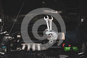 Car care maintenance and servicing, Hand technician auto mechanic using the wrench to fix car or repairing change spare part