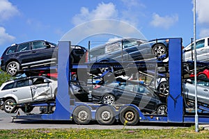 Car carrier trailer with used cars for sale on bunk platform