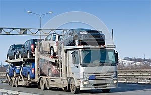 Car carrier truck deliver new auto batch to dealer photo