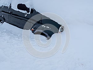 Car completely snowed in in winter