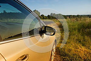 Car on the country road surrounded by nature.