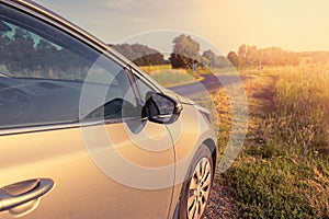 Car on the country road surrounded by nature.