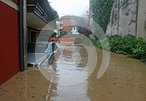 Car in the courtyard of the House submerged by flood mud