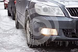 Car is covered icicles, snow and ice