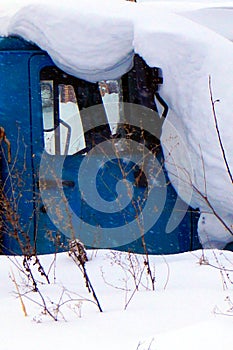 The car is covered in snow after heavy snowfall