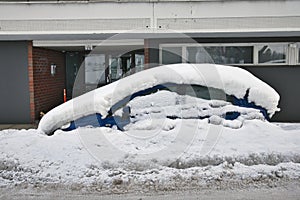 Car covered in snow parked on the street, Lappeenranta Finland