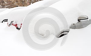 Car covered with snow in the parking