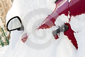 Car covered with snow in the parking