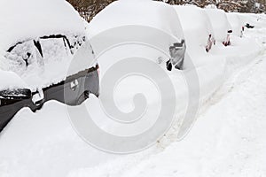 Car covered with snow in the parking