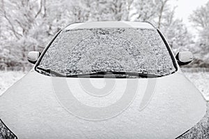 Car covered with snow during a snowfal