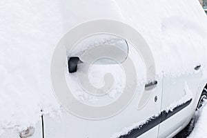 Car covered with snow after a storm