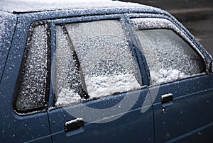 Car covered with snow on street