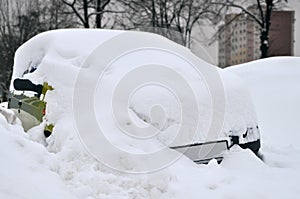 Car covered by snow during winter