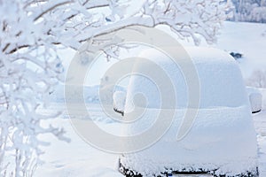 Car covered with snow after winter storm.