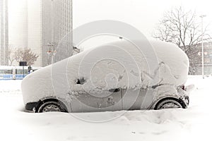 Car covered with snow in winter time