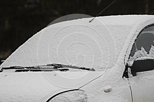 Car covered with snow, winter time and difficulties in driving