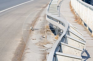 Car crash accident site. Damaged fence on the bridge from car crash accident