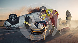 On the Car Crash Traffic Accident Scene: Paramedics Save Life of a Female Victim Lying on Stretche