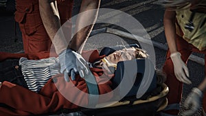 On the Car Crash Traffic Accident Scene: Paramedics Saving Life of a Female Victim who is Lying on
