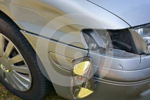 Car crash, the vehicle with a damaged fender, bumper and blinker