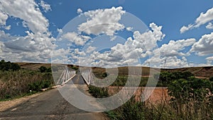 Car crosses a bridge on a bumpy road from Antsirabe to Miandrivazo in Madagascar