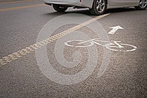 Car crossing bike lane on city road